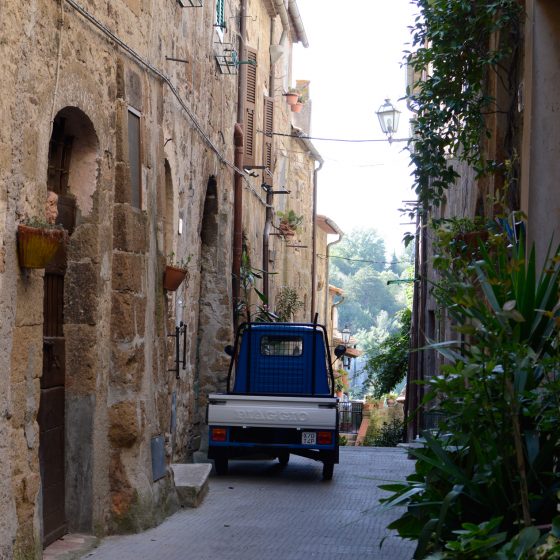 Pitigliano typical Piaggio parked outside house
