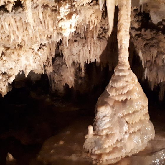Thin stalactite joining up with a wider stalagmite