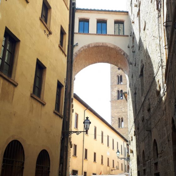 Volterra street with overhead bridge