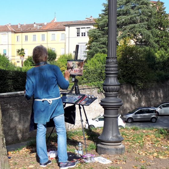 Artist at work on the walls of Lucca