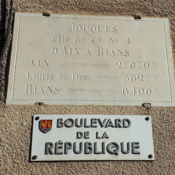 Old original road sign in Jouques along with modern one