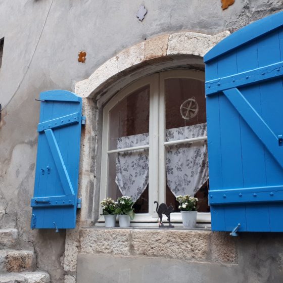 Pretty blue shutters on an old house in Moustiers