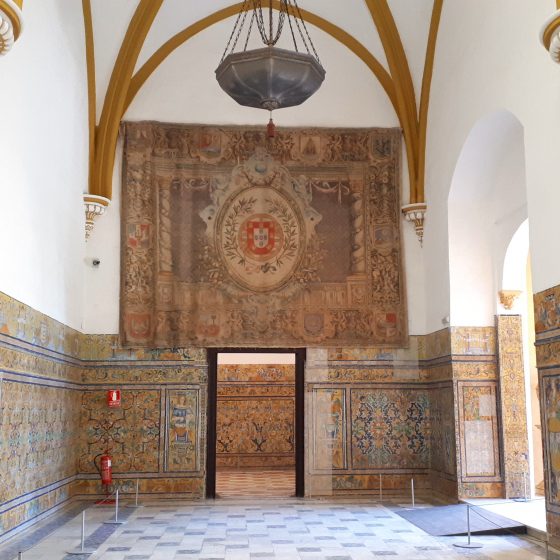Large tapestry and tiled walls in the Alcazar