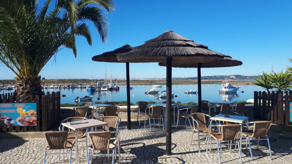 Attractive cobbled promenade and harbourside cafe at Alvor