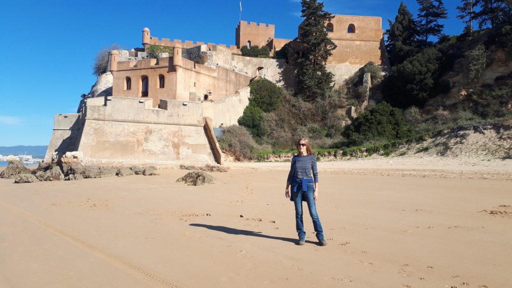 Ferragudo old castle on the hill and the long sandy beach