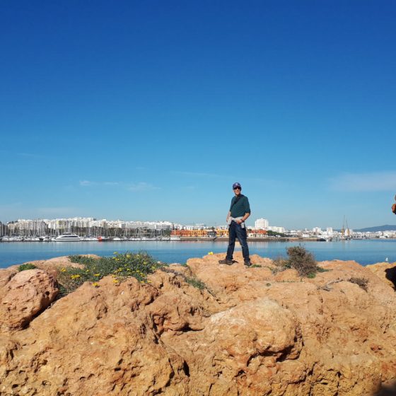 The rocky coastline and bright blue sea at Ferragudo