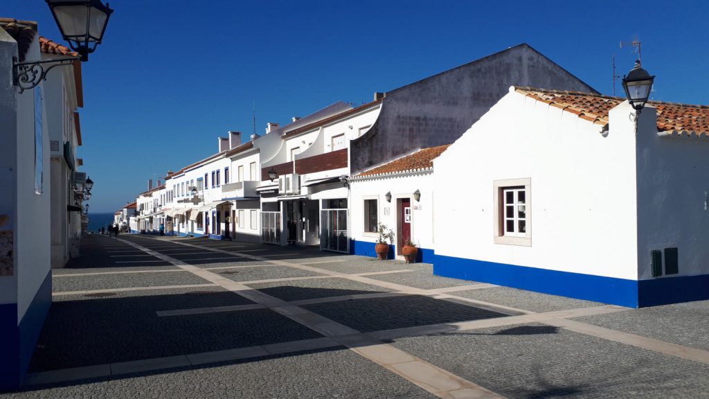 Porto Covo whitewashed town, promenade leading to the beach
