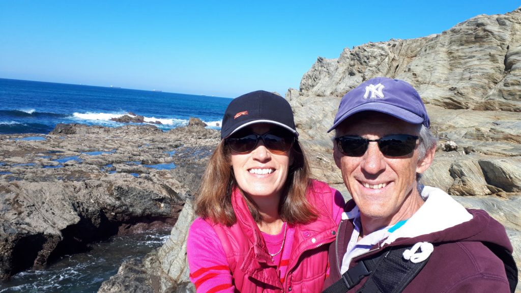 Trying not to get soaked on the rocks at Porto Covo