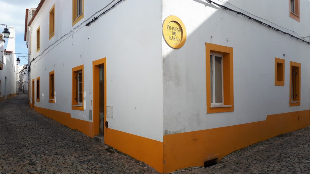 Residential streets of Evora with typical whitewashed buildings and yellow trim