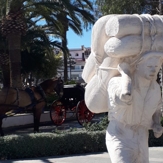 Sculpture and horses in the Plaza Virgen de la Pena