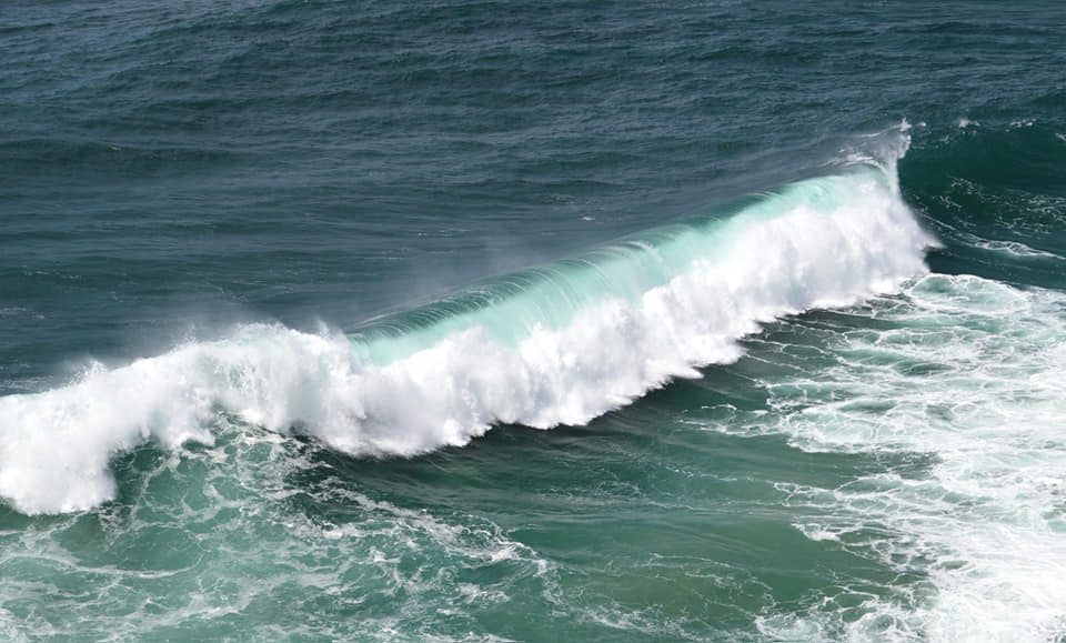 Big curling waves powering into shore