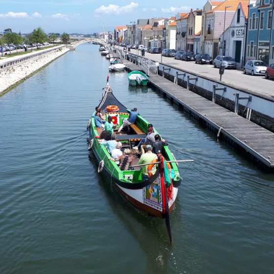 A tourist boat cruising along one of the canals on the edge of town