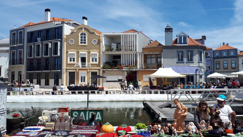 Market stalls piled high along the canalside