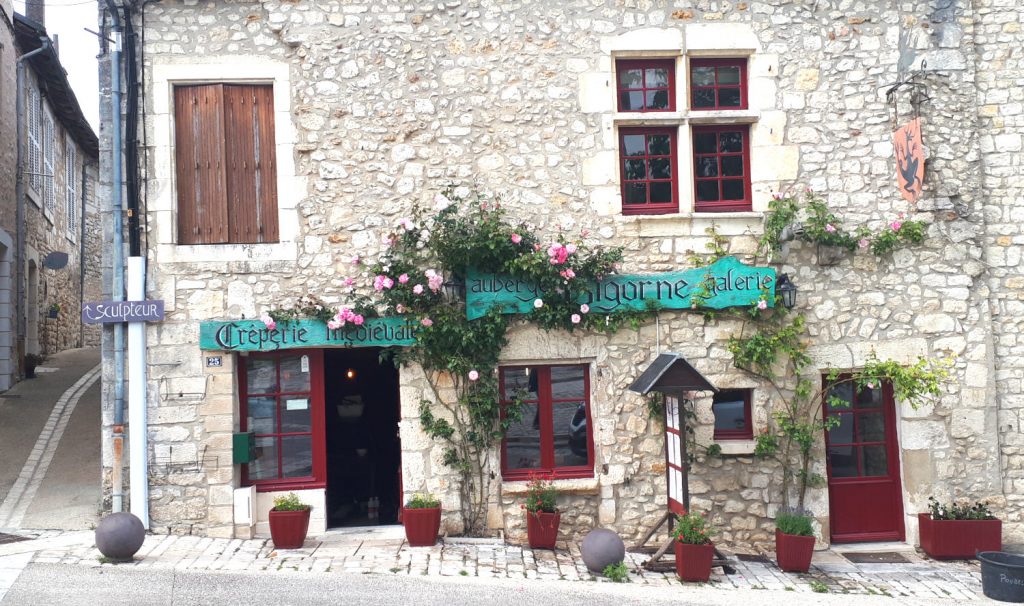 Medieval creperie with alleway leading to a sculptor's studio