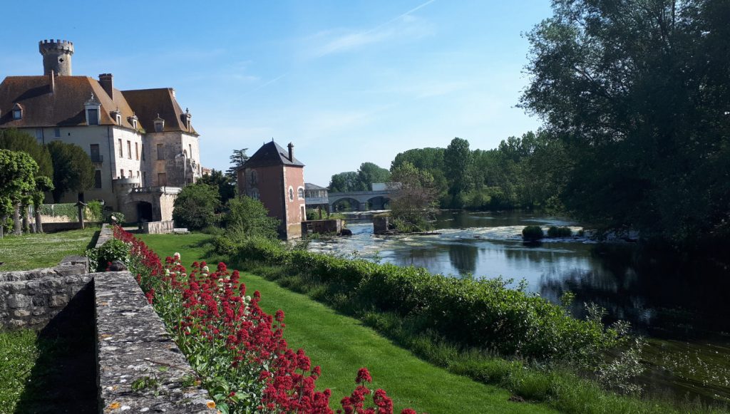 St Savin riverside , flowers and pink painted mill house