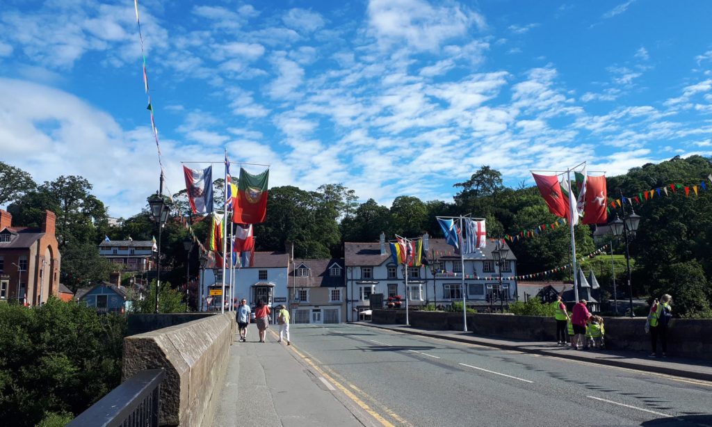 The road over the Llangollen bridge, with flags out for a festival.
