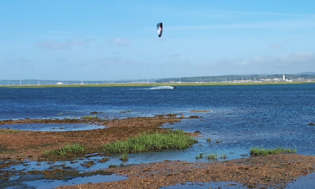 A kitesurfer making the most of the windy weather at Keyhaven Marshes