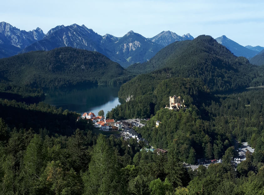Hohenschwangau Castle, lakes and snow topped mountains behind
