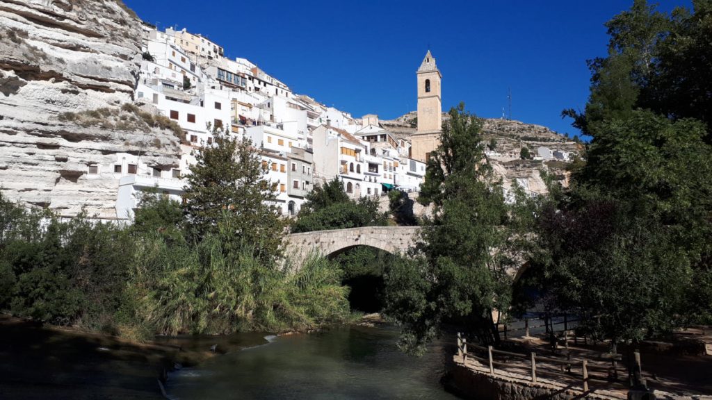 The pretty setting at the bottom of the town with river, old bridge and church tower