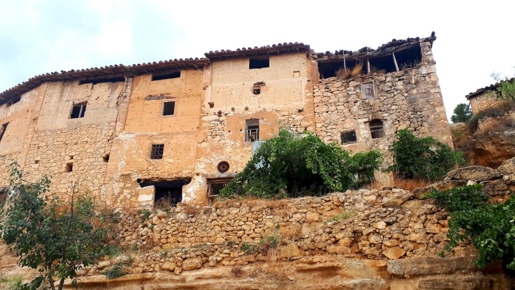 A row of mostly abandoned buildings at the top of the town