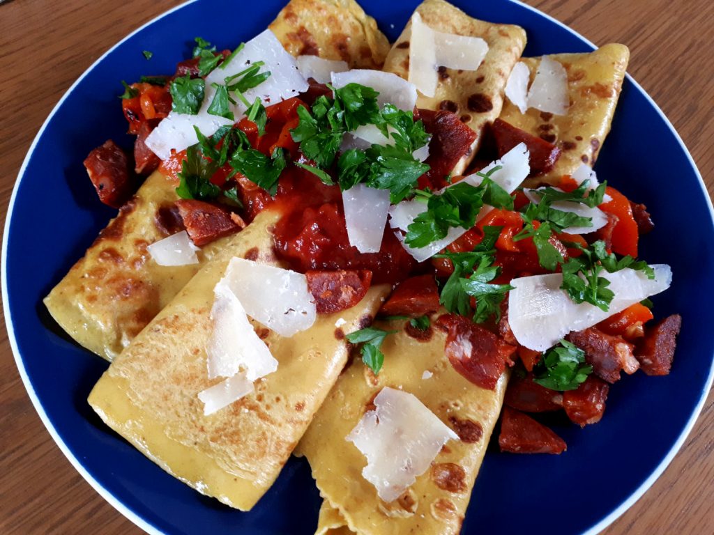 Spanish pancakes with spicy chorizo, red peppers, tomato salsa, manchego cheese and a sprinkle of parsley.