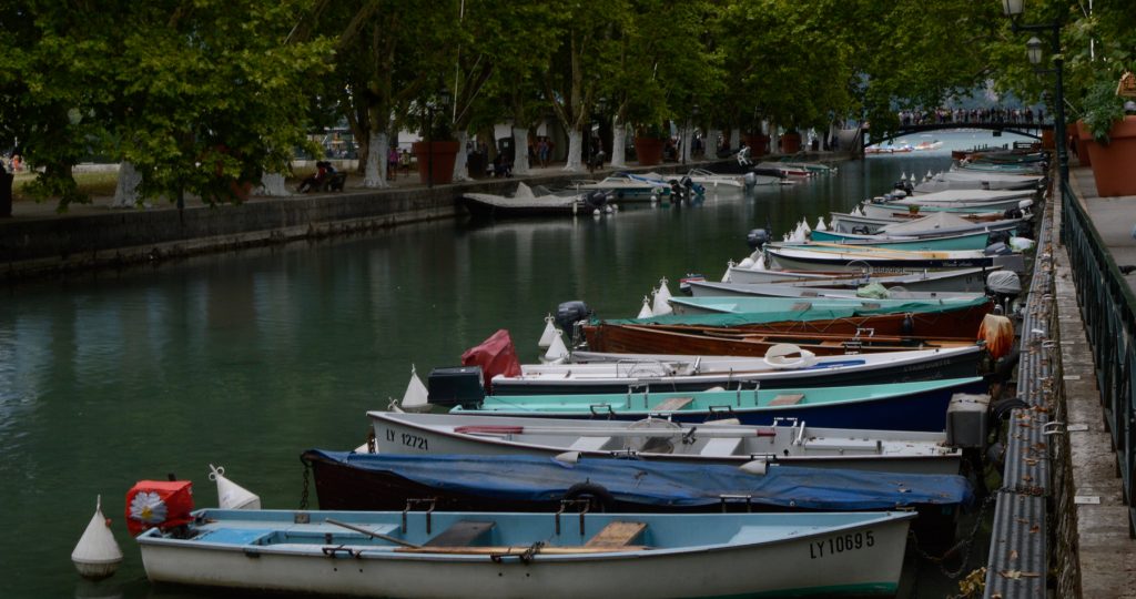 Annecy Canal with boats lined along the bank