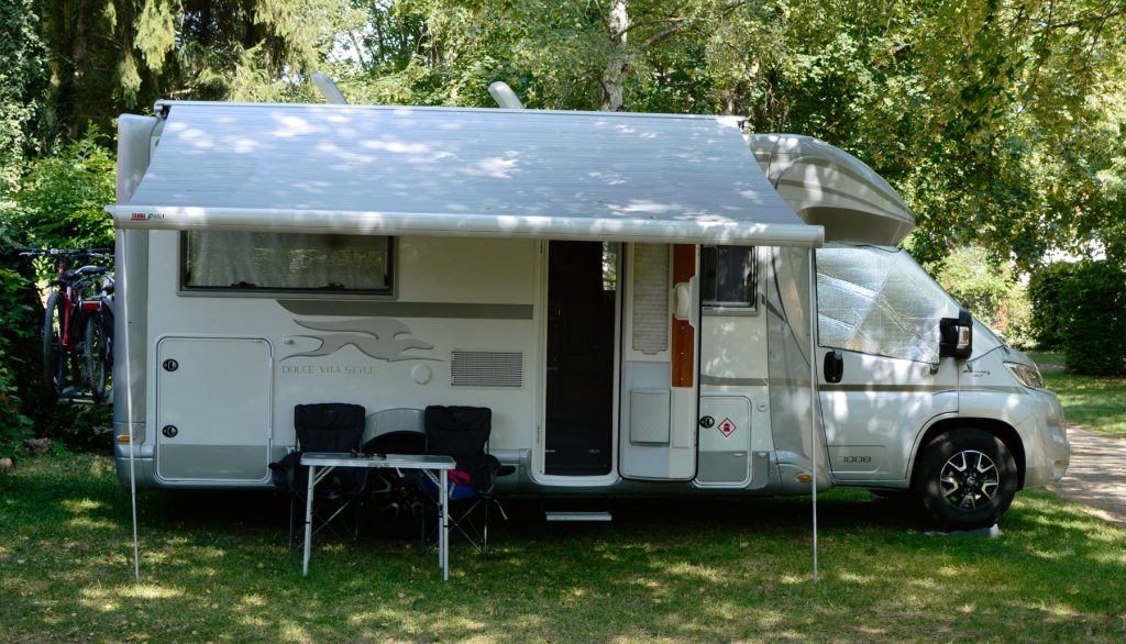 Vanlife Buzz parked at a campsite set up for the night