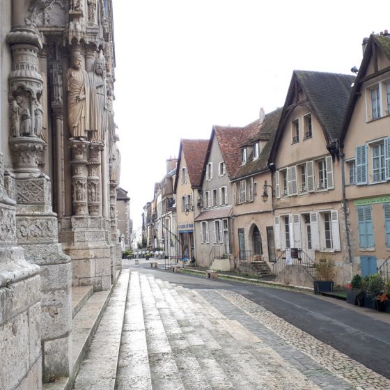 Pastel painted buildings in street opposite Chartres cathedral