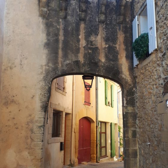 Medieval street with overhead walkway in Jouques