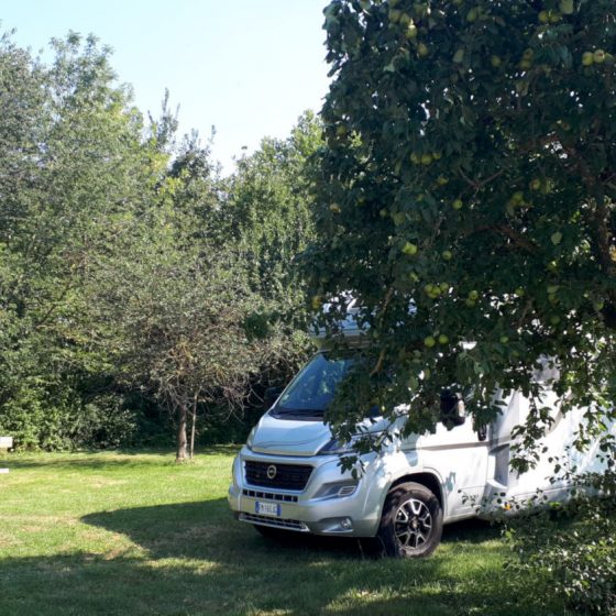 Motorhome parked in an apple orchard St Pierre