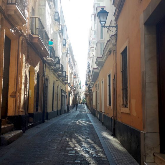 Cadiz street with typically tall brightly painted buildings