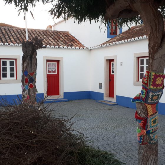 The town square at Porto Covo with knitted tree covers!