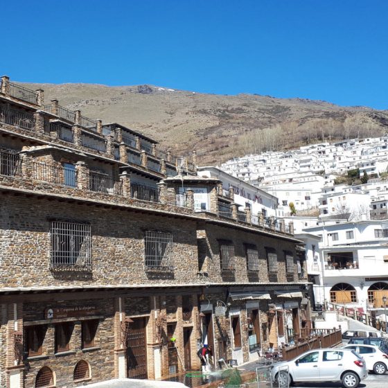 Open air ham drying buildings throughout the village