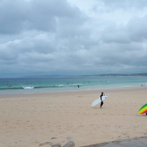 Surfers coming off the sea in Baleal