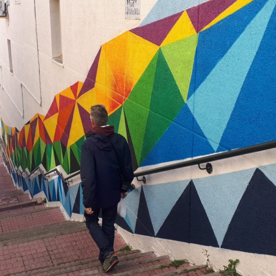 Colourfully painted wall alongside steps in Caceres