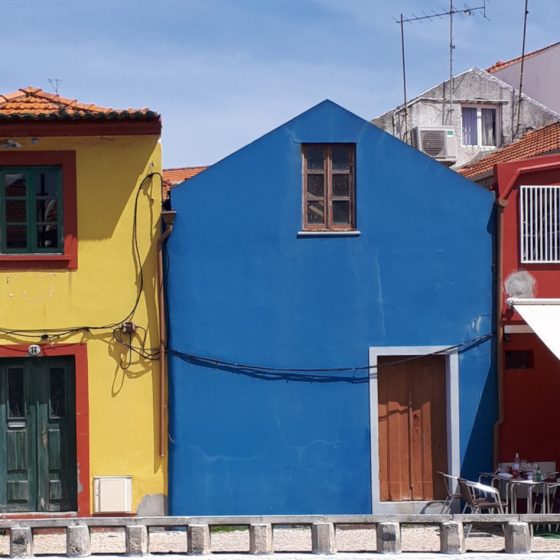 Small brightly coloured buildings lining the waterway