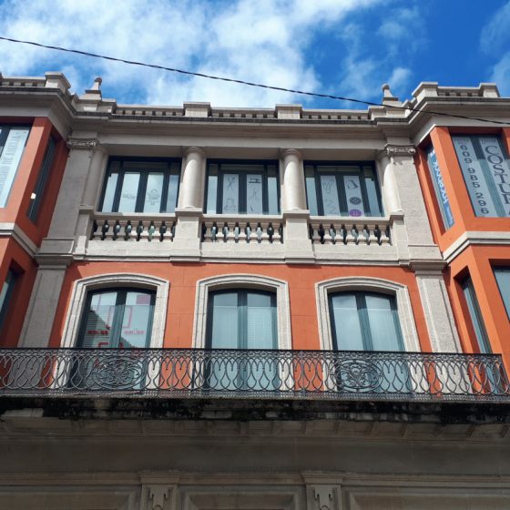 Bright orange building against bright blue sky.