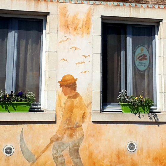 Artwork on a building in St Savin showing the local farming activities