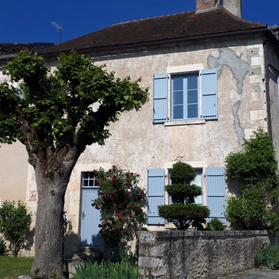 A beautiful stone house with pretty blue shutters