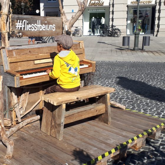 A little piano player having a grand old time