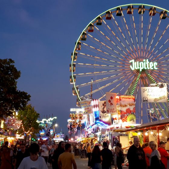 A huge big wheel lit up against the evening sky.